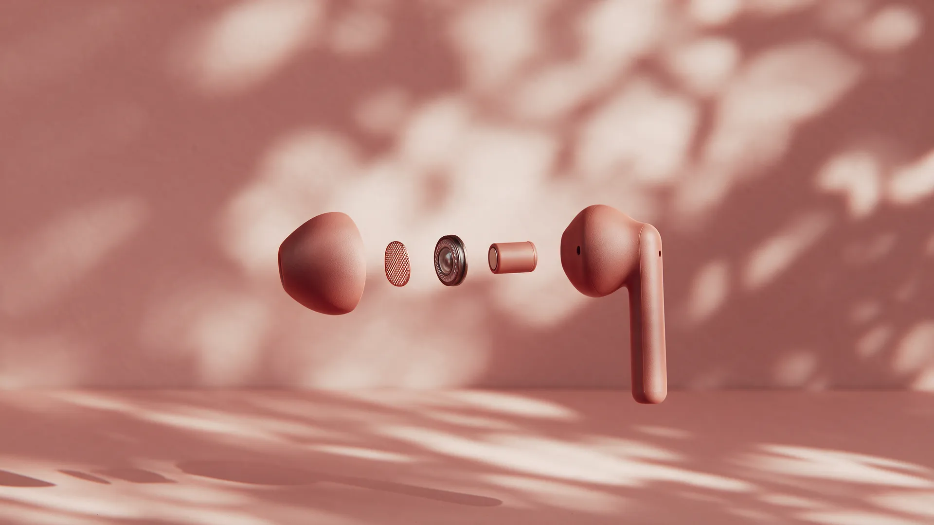 One earbud exploded into its parts in mid-air